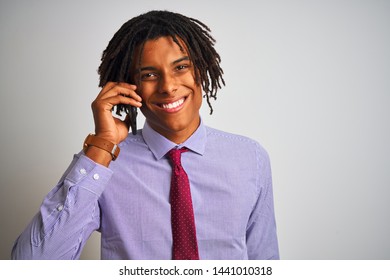 Afro businessman with dreadlocks talking using smartphone over isolated white background with a happy face standing and smiling with a confident smile showing teeth - Powered by Shutterstock