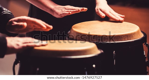 Afro Cuba, rum,\
drummer, fingers, hand, hit. Drum. Hands of a musician playing on\
bongs. The musician plays the bongo. Close up of musician hand\
playing bongos drums.