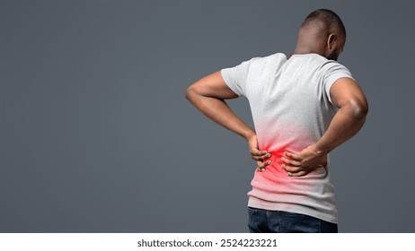 Afro guy holding both hands on lower back, pain in spine, inflamed zone highlighted in red, white background, free space - Powered by Shutterstock