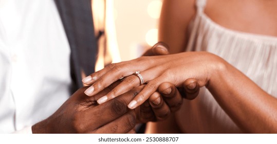 Afro guy putting diamond ring on his girlfriend finger, close up
