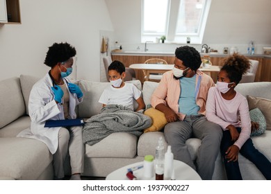Afro Health Visitor, Young Boy And His Family During Home Visit