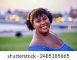 Afro Latina woman smiling with a bokeh background  