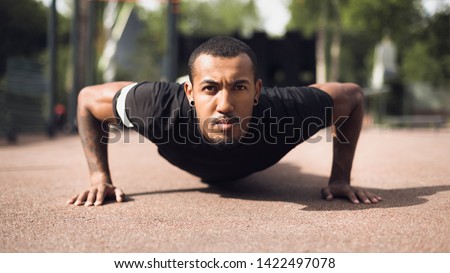 Afro Man Doing Push Ups On Sports Ground, Working Out In The Morning