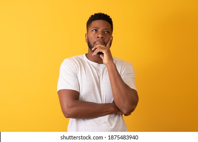 afro man thinking on yellow background with space for text - Shutterstock ID 1875483940