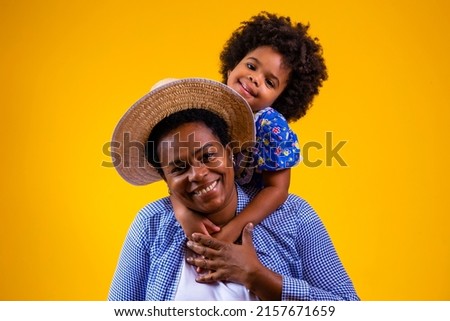 Afro mother and daughter dressed for june party. 