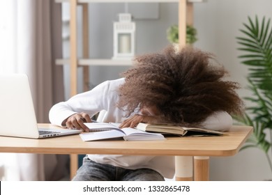 Afro Teen Schoolgirl Sitting At Home Or Classroom Lying On Desk Filled With Books Training Material And Notebook Schoolchild Sleeping Lazy Bored To Study Lack Of Energy Fatigue During Learning Concept