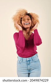 Afro Woman Touching Her Hair And Smiling While Standing Over An Isolated Background.