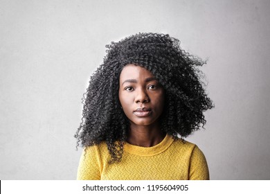 Afro woman in yellow sweater