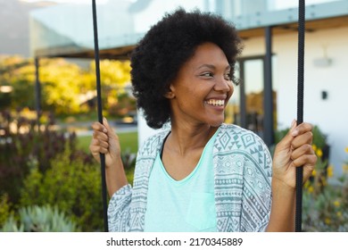 Afro Young African American Woman Smiling While Looking Away Outside House. Unaltered, Lifestyle And Simple Living Concept.