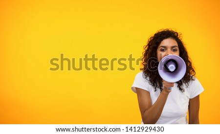 Afro-American female shouting in megaphone, public relations, social opinion