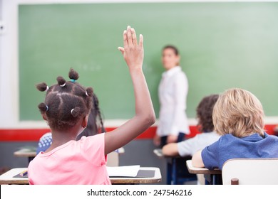 Afroamerican Female Student Raising Hand At School.