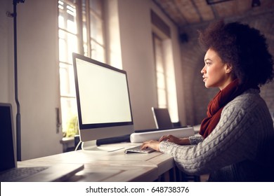 Afro-American Girl Working On Computer In Office 