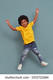 Afro-american kid jumping of happiness - Shutterstock ID 1923722684