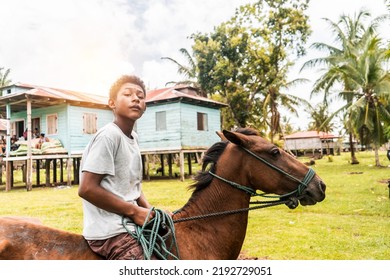 Afro-descendant Boy Riding A Horse In A Caribbean Community