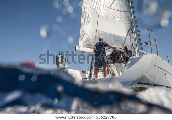 Aft of\
sailing boat with skipper from underwater\
view