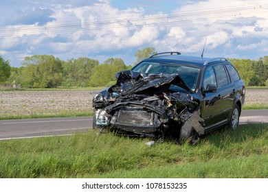After an accident, a car is on the side of the road, probably a total loss.  - Shutterstock ID 1078153235