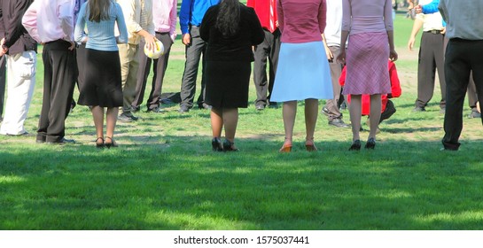 After Church Gathering With Men And Women On The Field Outdoors.