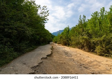 After An Earthquake And A Strong Storm, The Remains Of An Asphalt Road In The Mountains. Closed Road. Destroyed Asphalt Road. Broken Asphalt, Crack And Landslides. High Quality Photo