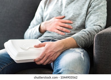 After Eating Fast Food. Man Feeling Full Or Taking Nap After Eating Junk. Guy Having Hangover Or Unhealthy Diet. Stomach Pain While Sitting On Couch.