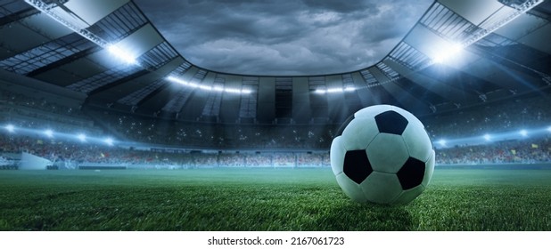 After game. Closeup soccer ball on grass of football field at crowded stadium with spotlights at evening time. Concept of sport, art, energy, power. Poster for ad, design - Powered by Shutterstock