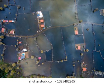 After heavy rain. Drone shot of the fields under water. Nature disaster. Flooded fields and houses.