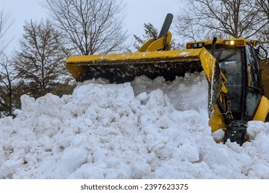 After heavy snowfalls, snowstorm snowplow trucks remove snow from parking lot
