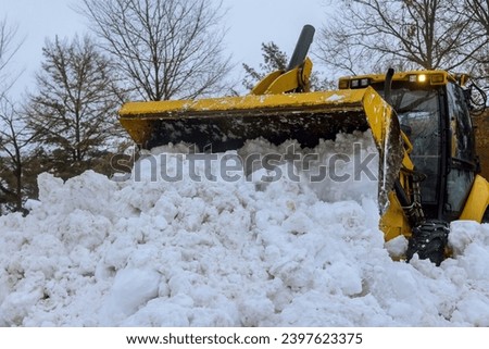 After heavy snowfalls, snowstorm snowplow trucks remove snow from parking lot