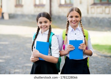 after literature lesson. prepare to exam. study together outdoor. girls with books and backpacks. children hold notebook for making note. happy childhood. back to school. teen pupils ready for lesson. - Powered by Shutterstock