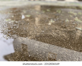 After raining water muddle shadows - Shutterstock ID 2312036169