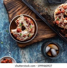 After School Snack Of A Pizza Bagel With A Bite Out Of It Served With A Glass  