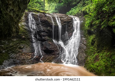 After Spring Rains, A Small Ephemeral Stream Splashes Over A Hidden Waterfall, Tucked Within A Rocky Green Ravine Just South Of St. Marys, West Virginia, And Swirls In The Pool Below.