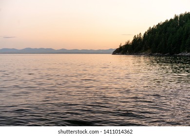 After sunset glow on the waters of Gibson's British Columbia with a mountainous skyline.
