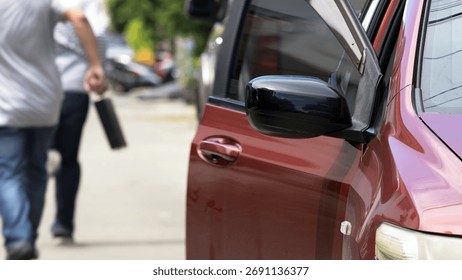 aftermath of an attempted robbery. Two men are seen walking away from red vehicle with its door still open, indicating hasty escape. thief is holding a black briefcase