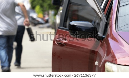 aftermath of an attempted robbery. Two men are seen walking away from red vehicle with its door still open, indicating hasty escape. thief is holding a black briefcase