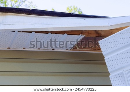 In aftermath of hurricane, master makes repairs to fascia trim
