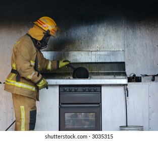 The Aftermath Of A Kitchen Oil Fire. A Firefighter Investigating The Cause.