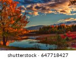 Afternoon in Acadia national park in October, with trees aglow, and beautiful reflections in pond