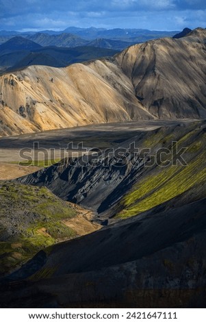 Afternoon light on the rugged volcanic landscape of Landmannalaugar as seen from the hiking trail from Brennisteinsalda volcano, Fjallabak Nature Reserve, Iceland.