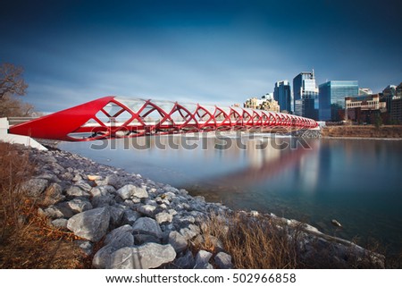 Afternoon photo of the Calgary Peace Bridge with Bow River and part of the Calgary downtown.