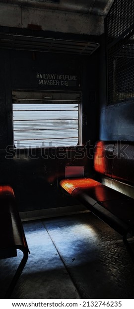 Afternoon\
sun light passing in an Train through window and seems like an\
person filled the window seat in the train\
seat