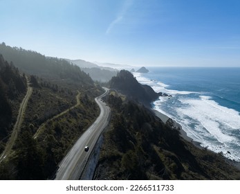 Afternoon sunlight shines on the southern coast of Oregon, along the Samuel H. Boardman State Scenic Corridor. This beautiful, rugged coastline is thickly forested and full of amazing viewpoints.