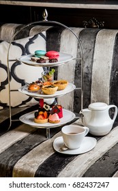 Afternoon Tea Dessert Set, There're Macaron, Cake, Sweet Serve On Beautiful Tray. Setting On Chess Sofa Shooting Display.