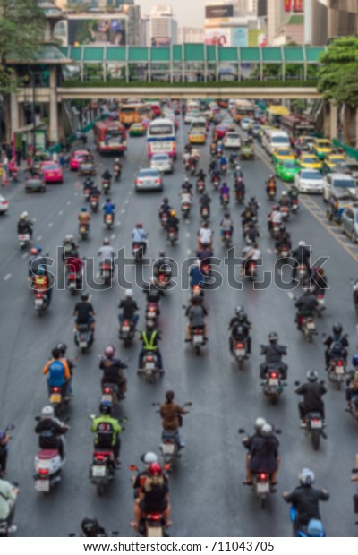 Afternoon traffic on\
Ratchaprasong Junction, next to Central world, Pathum Wan area.\
Rush hour for motorbikes, taxis and public transportation next to\
Erawan Shrine.\
Blurred.