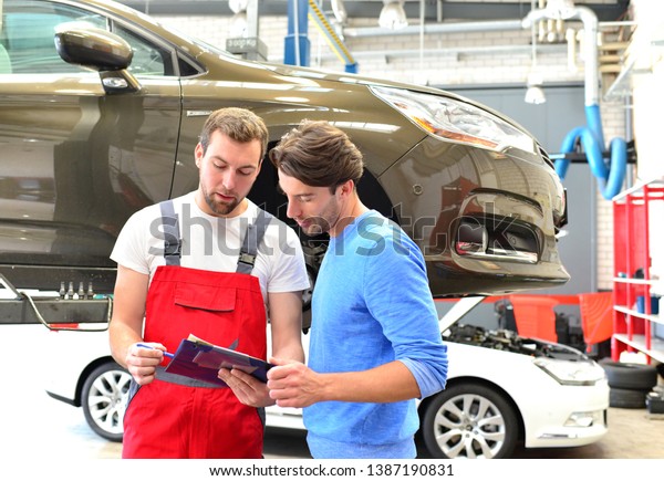after-sales service in the car\
repair shop - mechanic and man talk about repairing a vehicle\
