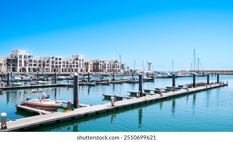 Agadir Marina in Morocco. Popular tourist area with luxury apartments, boats in harbor, shops and restaurants. Moroccan seaside resort on shore of Atlantic ocean in Africa