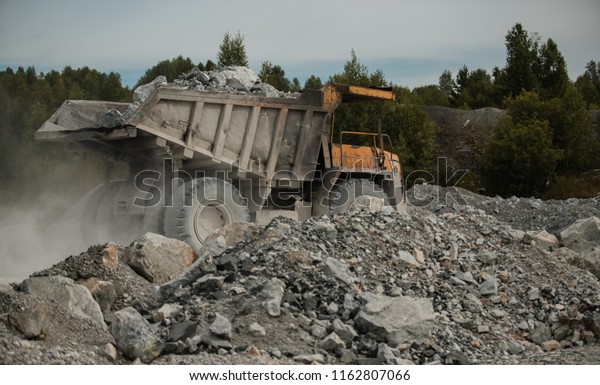 against a\
background of rubble, Mining industry. Heavy equipment. belaz\
movement. to transport rocks. miner\'s\
day