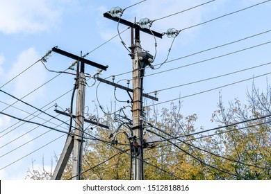 Against The Blue Cloudy Sky, Two Concrete Poles Of Power Lines, A Lot Of Wires. City Of Perm