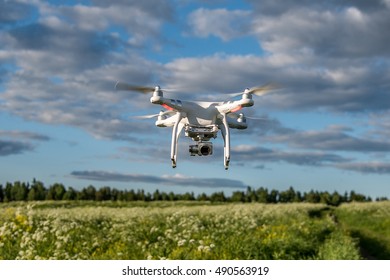 Agalatovo, Leningrad Region - JUNE 4, 2016: DJI Phantom 3 Advanced With High Resolution Digital Camera In Mid Air. New Tool For Aerial Photo And Video.