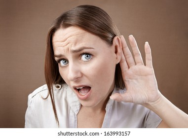 Agape Woman Holds Her Hand Behind Her Ear Trying To Listen