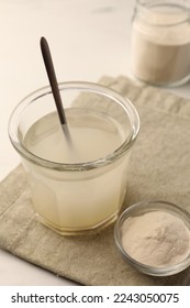 Agar-agar jelly and powder on white table, closeup - Shutterstock ID 2243050075